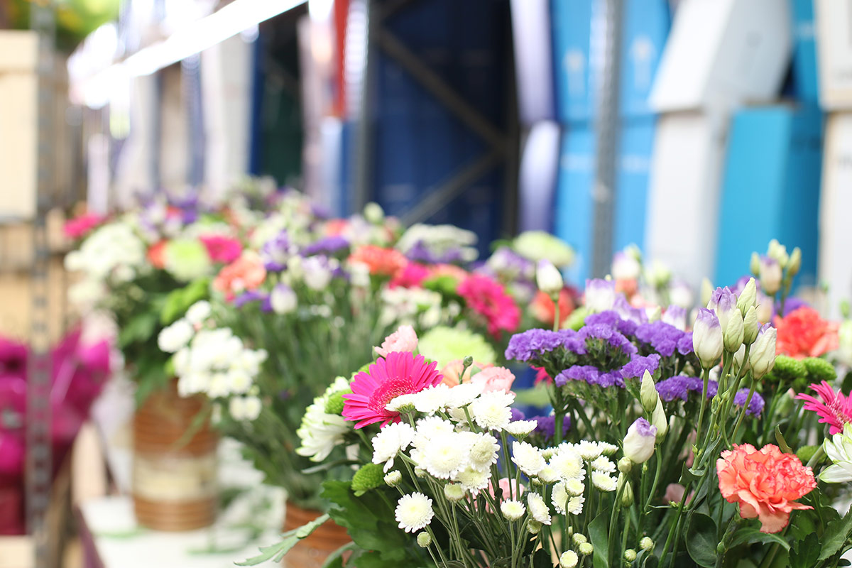 Corporate flowers with branded boxes behind